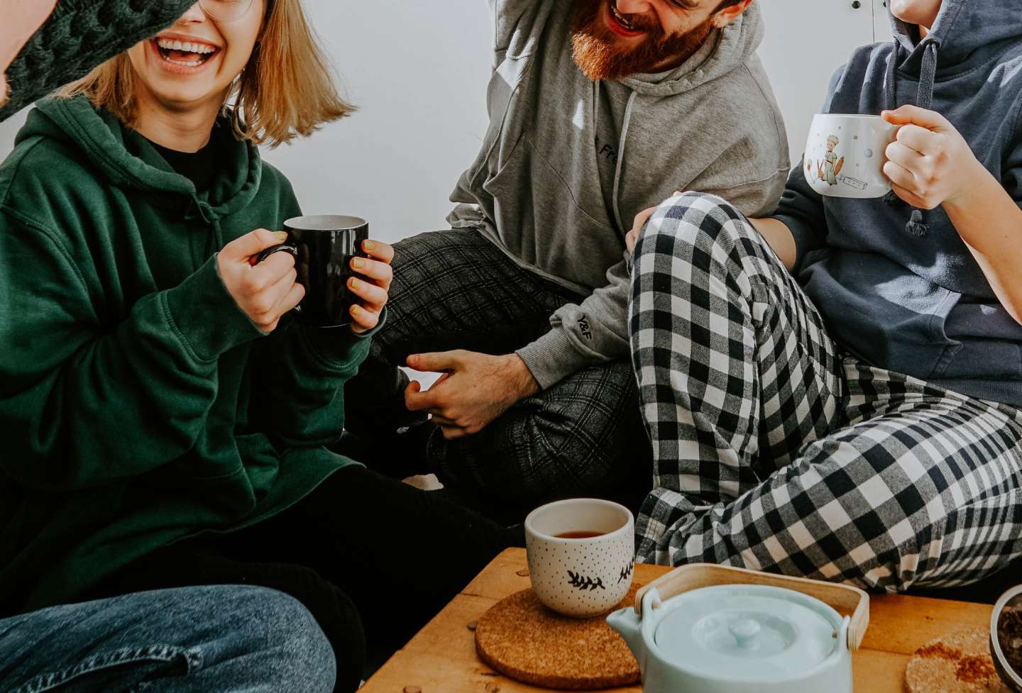 Friends enjoying coffee and laughing.